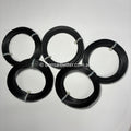 Five coils of black wire on a white background